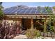 Home with solar panels on roof and covered patio at 10372 Hawks Wing St, Las Vegas, NV 89178