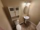 Clean bathroom with pedestal sink, toilet and a wall cabinet at 121 E Cypress Dr, Henderson, NV 89015