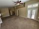 Spacious Primary bedroom with carpet, high ceilings, and French doors leading to backyard at 121 E Cypress Dr, Henderson, NV 89015