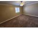 Spacious bedroom with carpeted floor, ceiling fan, and window shutters at 121 E Cypress Dr, Henderson, NV 89015