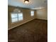 Large bedroom with two windows, carpet, and a ceiling fan at 121 E Cypress Dr, Henderson, NV 89015