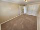 Bright bedroom with neutral walls, carpet and doors to hallway at 121 E Cypress Dr, Henderson, NV 89015