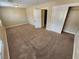 Well-lit bedroom with carpet flooring and double doors to the hallway at 121 E Cypress Dr, Henderson, NV 89015