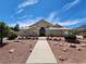 Tan stucco home with tile roof and walkway at 121 E Cypress Dr, Henderson, NV 89015