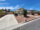 Landscaped front yard with driveway and gated entry at 121 E Cypress Dr, Henderson, NV 89015