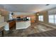 Open kitchen with island, wood cabinetry, and tile flooring. Includes breakfast nook at 121 E Cypress Dr, Henderson, NV 89015