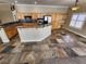 Open kitchen boasts granite countertops, stainless steel appliances, and tile floors at 121 E Cypress Dr, Henderson, NV 89015