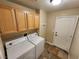 Laundry room with washer, dryer, and wooden cabinets at 121 E Cypress Dr, Henderson, NV 89015