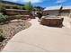 Landscaped backyard featuring a large pool, spa, and waterfall feature at 121 E Cypress Dr, Henderson, NV 89015
