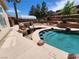 Backyard with a stunning pool, built-in BBQ, and swim-up bar at 121 E Cypress Dr, Henderson, NV 89015