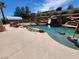Expansive backyard with a large pool, waterfall, and BBQ area at 121 E Cypress Dr, Henderson, NV 89015