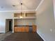 Built-in wet bar with wood cabinets and granite countertop at 121 E Cypress Dr, Henderson, NV 89015