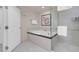 Clean bathroom features a soaking tub, glass shower, and white tiled floor at 135 E Harmon Ave # 1007, Las Vegas, NV 89109