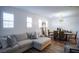 Bright living room boasts a comfy sectional sofa and wood-look floors at 161 Petaluma Valley Dr, Las Vegas, NV 89138