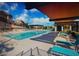 Community pool with lounge chairs and shade structures at 161 Petaluma Valley Dr, Las Vegas, NV 89138