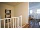 Upstairs hallway with white railing and beach-themed art at 161 Petaluma Valley Dr, Las Vegas, NV 89138