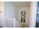 Upstairs hallway showcasing a white railing and artwork at 161 Petaluma Valley Dr, Las Vegas, NV 89138