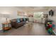 Living room with brown leather couch and gray wood-look floors at 2068 Mesquite Ln # 203, Laughlin, NV 89029