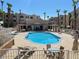 Community pool with lounge chairs and patio tables at 2068 Mesquite Ln # 203, Laughlin, NV 89029