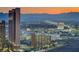 City skyline view at dusk featuring a tall building and mountain range in background at 222 Karen Ave # 2601, Las Vegas, NV 89109