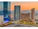 Aerial city view at sunset showcasing several high-rise buildings and mountain backdrop at 222 Karen Ave # 2601, Las Vegas, NV 89109