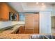 Modern kitchen with wood cabinets, granite counters, and stainless steel appliances at 222 Karen Ave # 2601, Las Vegas, NV 89109