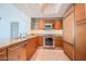 Modern kitchen with wood cabinets, granite counters, and stainless steel appliances at 222 Karen Ave # 2601, Las Vegas, NV 89109