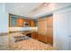 Modern kitchen with wood cabinets, granite counters, and stainless steel appliances at 222 Karen Ave # 2601, Las Vegas, NV 89109