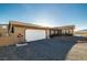 House exterior with a white garage door and a small, landscaped yard at 2300 W Mielzynski Way, Pahrump, NV 89048