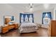 Main bedroom with wood floors, a dresser, and a ceiling fan at 2300 W Mielzynski Way, Pahrump, NV 89048