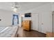 Main bedroom with a ceiling fan and en-suite bathroom access at 2300 W Mielzynski Way, Pahrump, NV 89048