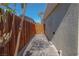 Private backyard access through a wooden gate and along a paved pathway at 2408 Berkley Ave, Las Vegas, NV 89101