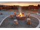 Stone firepit with log seating in gravel area at 2770 S Peggy St, Pahrump, NV 89048