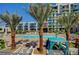 Inviting pool area with palm trees and cabanas at 353 E Bonneville Ave # 457, Las Vegas, NV 89101