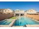 Large rectangular pool and spa with grassy area at 43 Flora Sagio Ave, Henderson, NV 89011