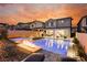 Expansive pool and spa at sunset, fire pit feature at 43 Flora Sagio Ave, Henderson, NV 89011