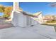 Home exterior featuring sliding glass door that leads to an extended patio with a stucco chimney at 4536 Rolls Royce Rd, North Las Vegas, NV 89031