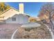 A view of the backyard of a one-story home featuring a concrete patio and a low-maintenance landscape at 4536 Rolls Royce Rd, North Las Vegas, NV 89031