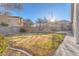 Spacious backyard with grassy area and pathway at 4536 Rolls Royce Rd, North Las Vegas, NV 89031