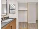 Bathroom vanity with modern fixtures, and a large, sliding-door closet, offering ample storage at 4536 Rolls Royce Rd, North Las Vegas, NV 89031