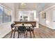 Dining area with a wooden table, modern chairs, and views into the kitchen at 4536 Rolls Royce Rd, North Las Vegas, NV 89031