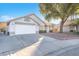 House exterior featuring a two-car garage and well-maintained landscaping at 4536 Rolls Royce Rd, North Las Vegas, NV 89031