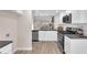 Bright kitchen featuring stone countertops, white cabinets, and modern stainless steel appliances at 4536 Rolls Royce Rd, North Las Vegas, NV 89031