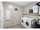 Convenient laundry room with washer, dryer, and storage at 4601 Peppertree St, Pahrump, NV 89061