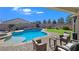 Covered patio overlooking a refreshing pool and spa at 4601 Peppertree St, Pahrump, NV 89061