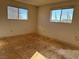Simple bedroom with two windows and wood flooring needing refinishing at 4980 W Weddle Way, Moapa, NV 89025