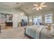 Main bedroom with carpet, king bed, and views of the backyard at 5116 N Valadez St, Las Vegas, NV 89149