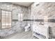 Modern bathroom with marble-tiled walls and a sleek vanity at 7428 Radville Dr, Las Vegas, NV 89129