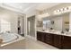 Spa-like bathroom with soaking tub, walk-in shower, and double vanity at 7670 Frittata Ave, Las Vegas, NV 89113