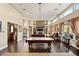 Spacious game room with pool table, fireplace, and ample seating at 7670 Frittata Ave, Las Vegas, NV 89113